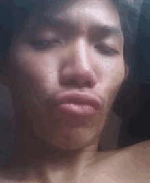 a close up of a man 's face with his eyes closed and his mouth open
