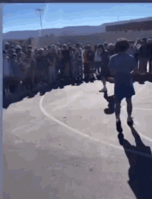 a group of people are standing in a line on a basketball court