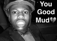 a black and white photo of a man wearing a helmet with the words " you good mud " above him