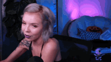 a woman with purple lipstick is sitting in front of a chair with a pumpkin on it that says wc