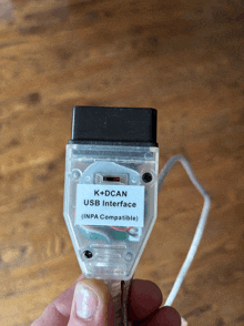 a person is holding a clear usb interface