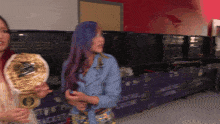 two women are standing in front of a sign that says ' backstage ' on it
