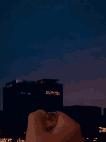 a person is holding a diamond shaped object that is glowing in the dark