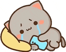 a cartoon cat is crying while laying on a pillow .