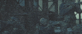 a man in a gas mask holds a gun while standing next to another man