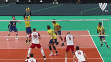 a group of men are playing volleyball on a court and one of the players has the number 20 on his shirt