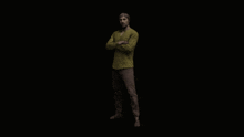 a man in a yellow shirt is dancing in the dark