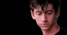 a close up of a young man 's face with his eyes closed and ear buds in his ears .
