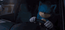 a blue sonic the hedgehog is driving a car and says huh ?