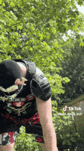 a man wearing knee pads and a shirt that says ' mad hawk dub ' on it