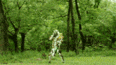 a person in a robot costume is standing in a field with trees in the background