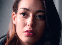 a close up of a woman 's face with dark hair