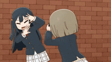 two anime girls are standing in front of a brick wall and one is taking a picture