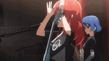 a girl with red hair is playing a blue guitar