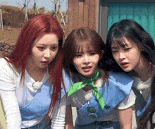 three girls are standing next to each other and one has a green bandana around her neck that says ' a ' on it