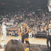 a basketball player with the number 25 on his jersey stands on the court