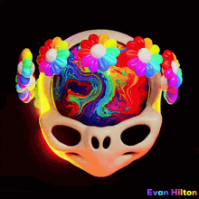 a colorful alien head with flowers on it and the name evan hilton below it