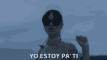 a woman wearing sunglasses and a dress says yo estoy pa ' ti