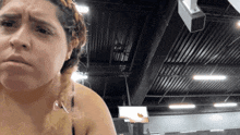 a woman in a braided ponytail is making a funny face