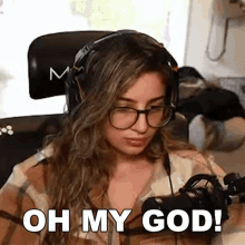 a woman wearing headphones and glasses is sitting in front of a microphone and says `` oh my god '' .