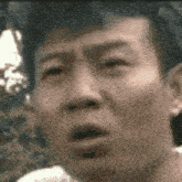 a close up of a man 's face with his mouth open in a blurry photo .