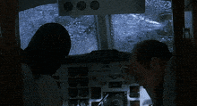 a man in a mask is looking out of a plane window