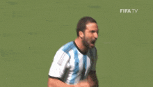 two soccer players are running on a field with jupiler ads on the side