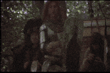 a man with long red hair is holding a shield with a rooster on it