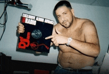 a shirtless man is holding up a record labeled exclusive alumni advance