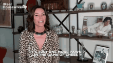 a woman in a leopard print shirt says it 's just one more pawn in a game of chess