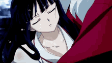 a girl with long black hair is laying on a man 's shoulder .