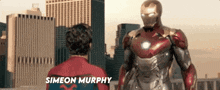 a man in a spiderman suit is standing next to a man in a iron man suit