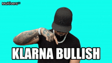 a man wearing a hat and a necklace says klarna bullish on a blue background