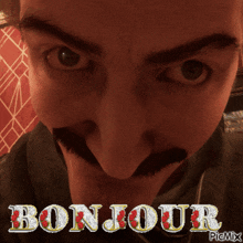 a close up of a man 's face with the words bonjour on the bottom