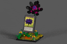 a lego model of a purple flower with a card that says " meditation " on it