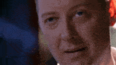 a close up of a man 's face with a red eye
