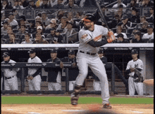 a baseball player getting ready to swing his bat with a bank of america banner in the outfield