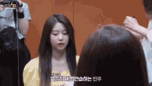 a girl in a yellow dress is being photographed by a man with the word end21 on the bottom
