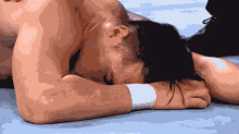 a man laying on the ground with his head on his hands