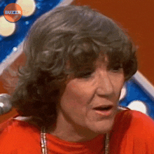 a close up of a woman 's face with buzzr written in the corner