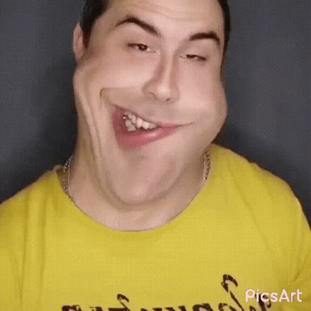 a man wearing a yellow shirt is making a funny face