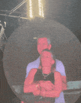 a woman in a red shirt is standing in front of a large circle