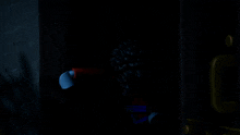 a blue lego figure with a red cape is laying down with his mouth open