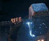 a woman in a helmet is holding a hammer with the letter c on it