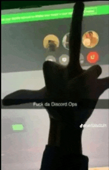 a person giving the middle finger in front of a screen that says " fuck da discord ops "