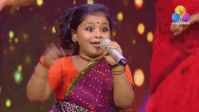a little girl singing into a microphone with flowers hd on the bottom
