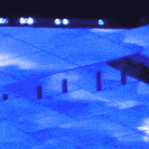 a blue tiled floor with a hole in the middle of it