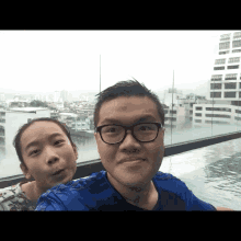 a man and a woman are posing for a picture in a pool