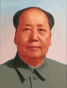 a close up of a man 's face wearing a green jacket