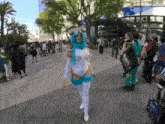 a woman in a white and blue costume is walking down a street